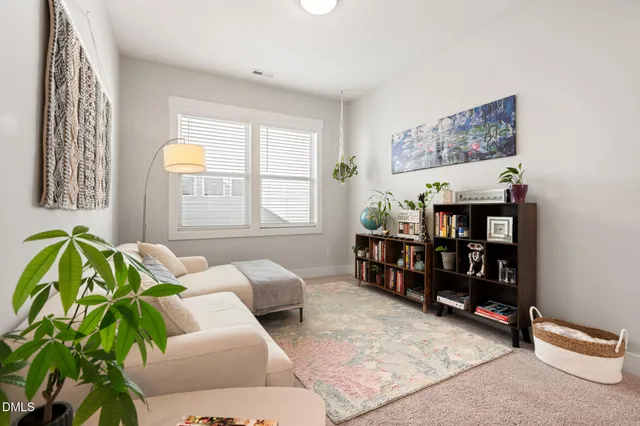 a living room with furniture toys and a window