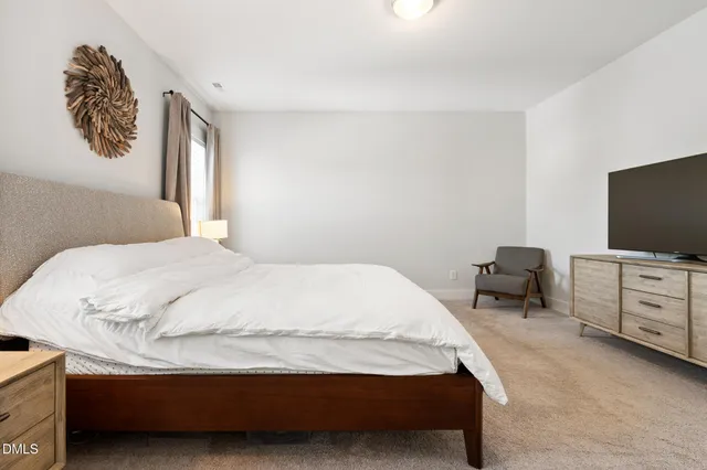 a bedroom with a bed and flat screen tv