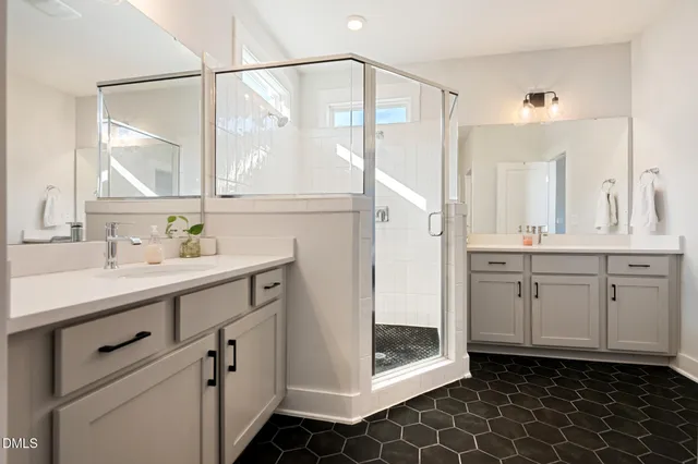 a bathroom with a double vanity sink mirror and