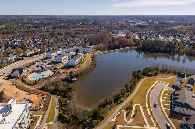 an aerial view of a house with a swimming pool and outdoor seating