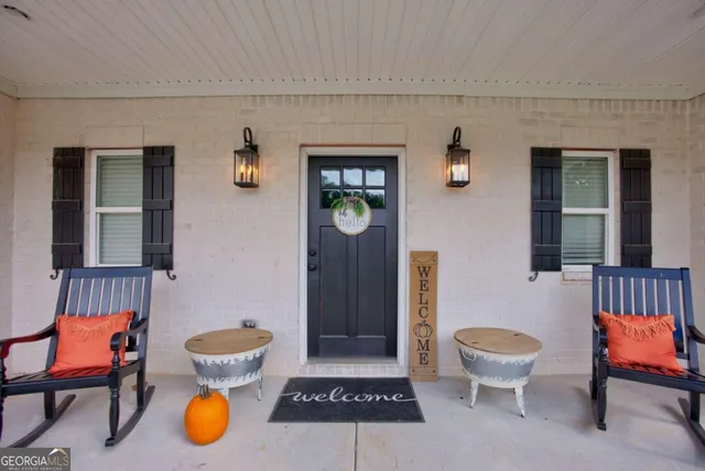 a living room with a couch and a chandelier