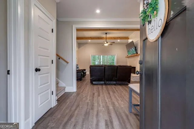 a view of a hallway view with wooden floor and staircase