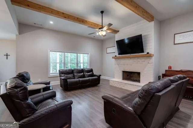 a living room with furniture a fireplace and a flat screen tv