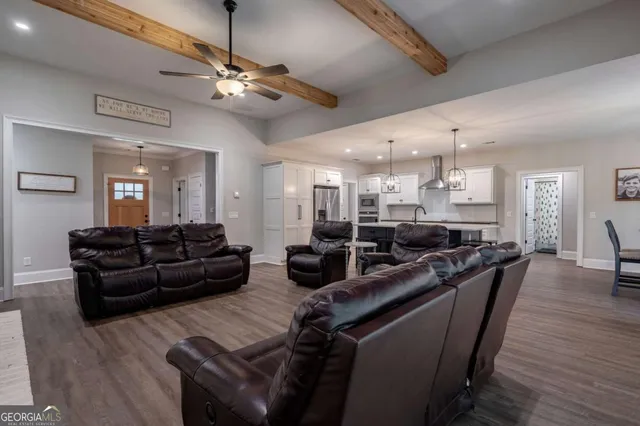 a living room with furniture and a dining room