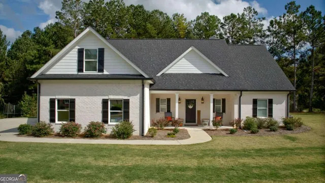 a front view of a house with a yard garage and outdoor seating