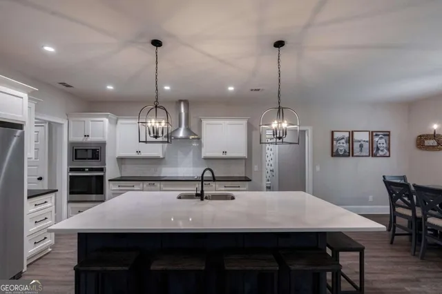 a kitchen with a sink a counter space cabinets and stainless steel appliances