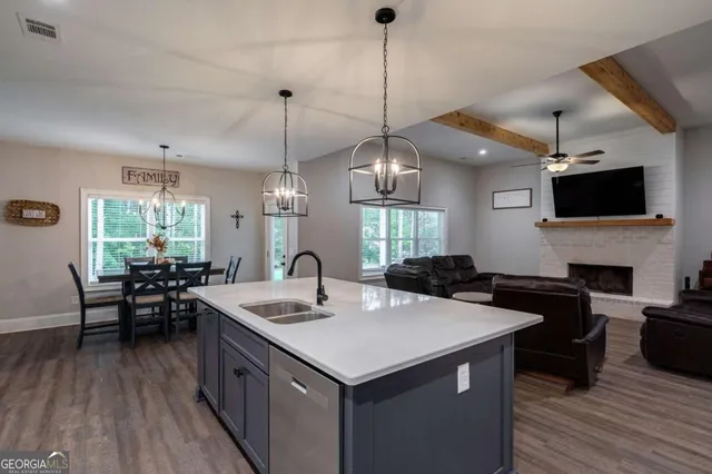 a kitchen with sink stove and cabinets