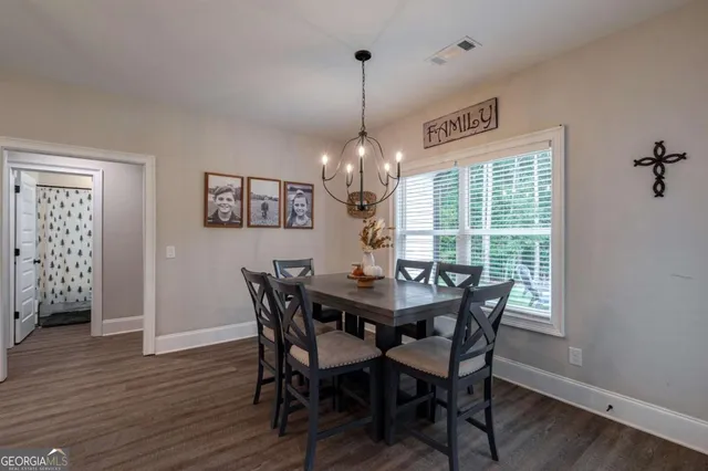 a bathroom with a granite countertop sink and a toilet