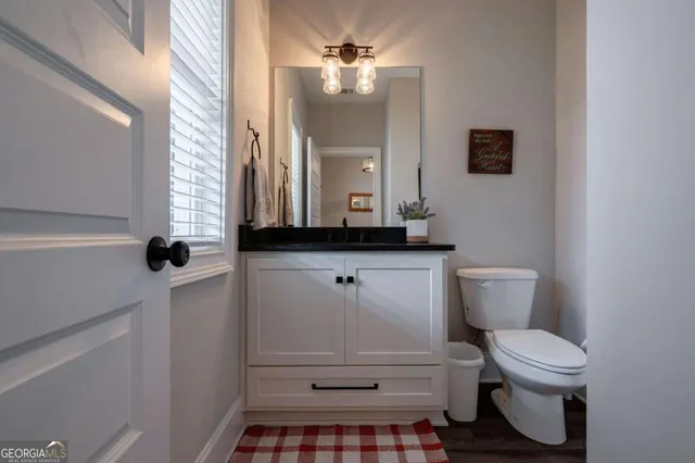 a living room with furniture and a ceiling fan