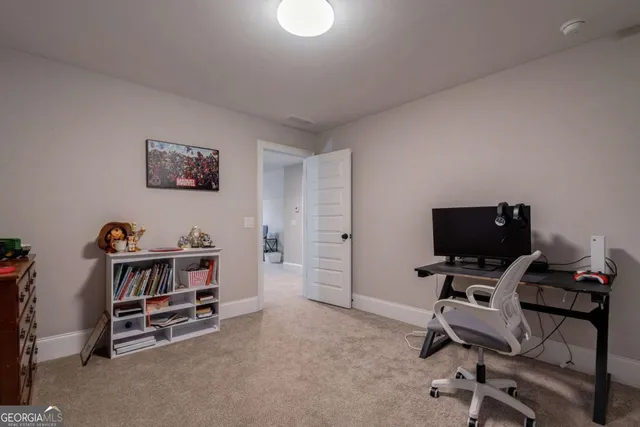 an aerial view of a residential houses with outdoor space and trees