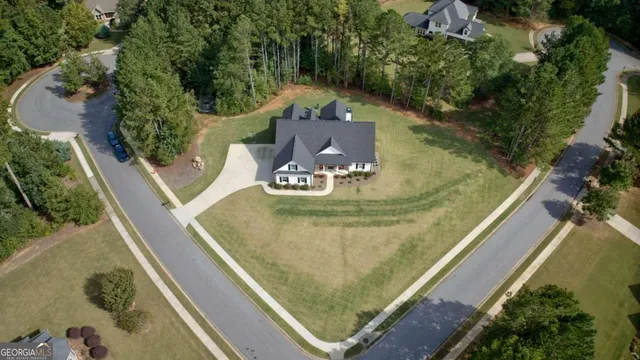 an aerial view of a house with outdoor space
