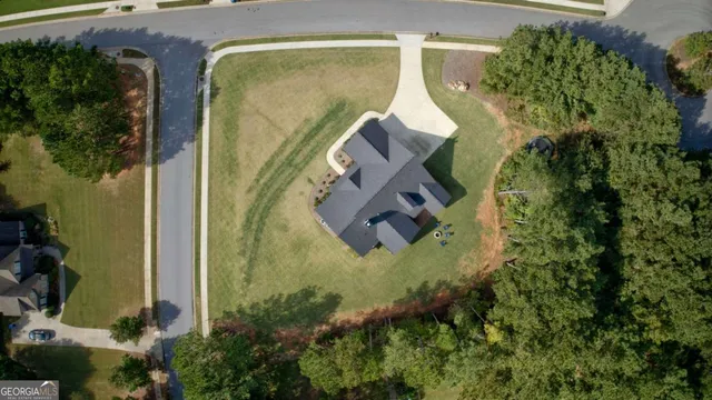 an aerial view of a house with outdoor space and a lake view