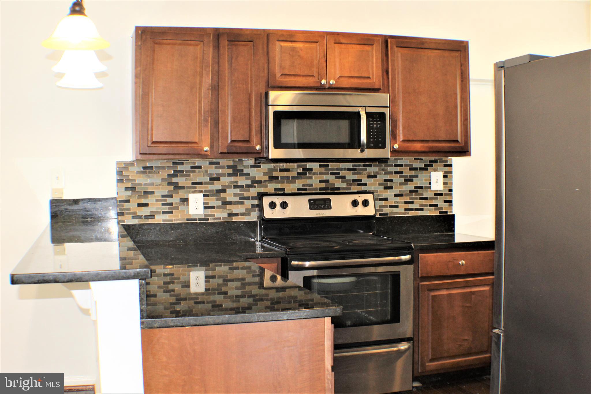 6418 Dogwood Road Baltimore, MD 21207 - Photo 11 of 33 Kitchen w/ Granite Counter Top and Back Splash