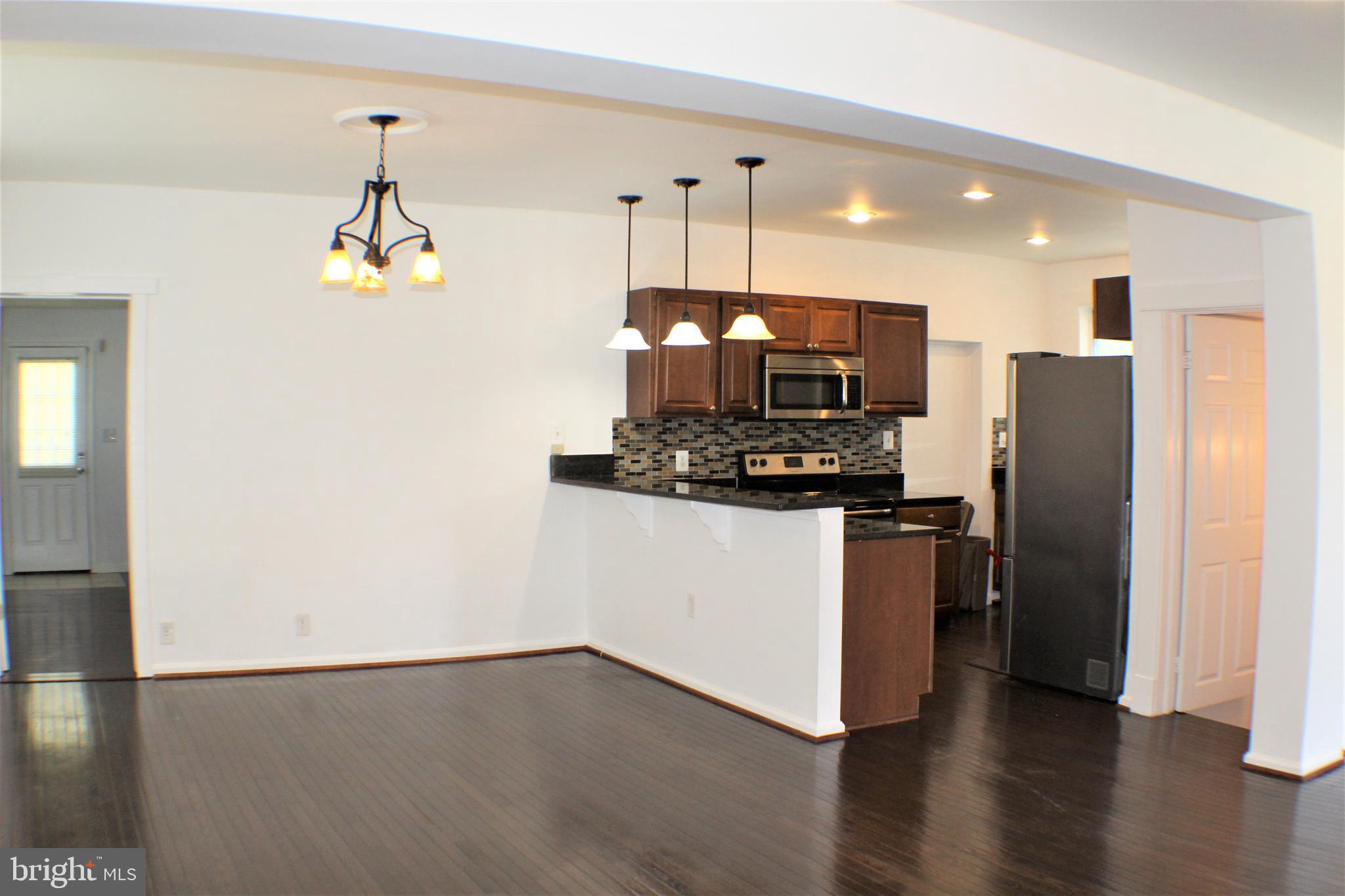 6418 Dogwood Road Baltimore, MD 21207 - Photo 9 of 33 Dining Room and Kitchen w/ view of Master Bedroom