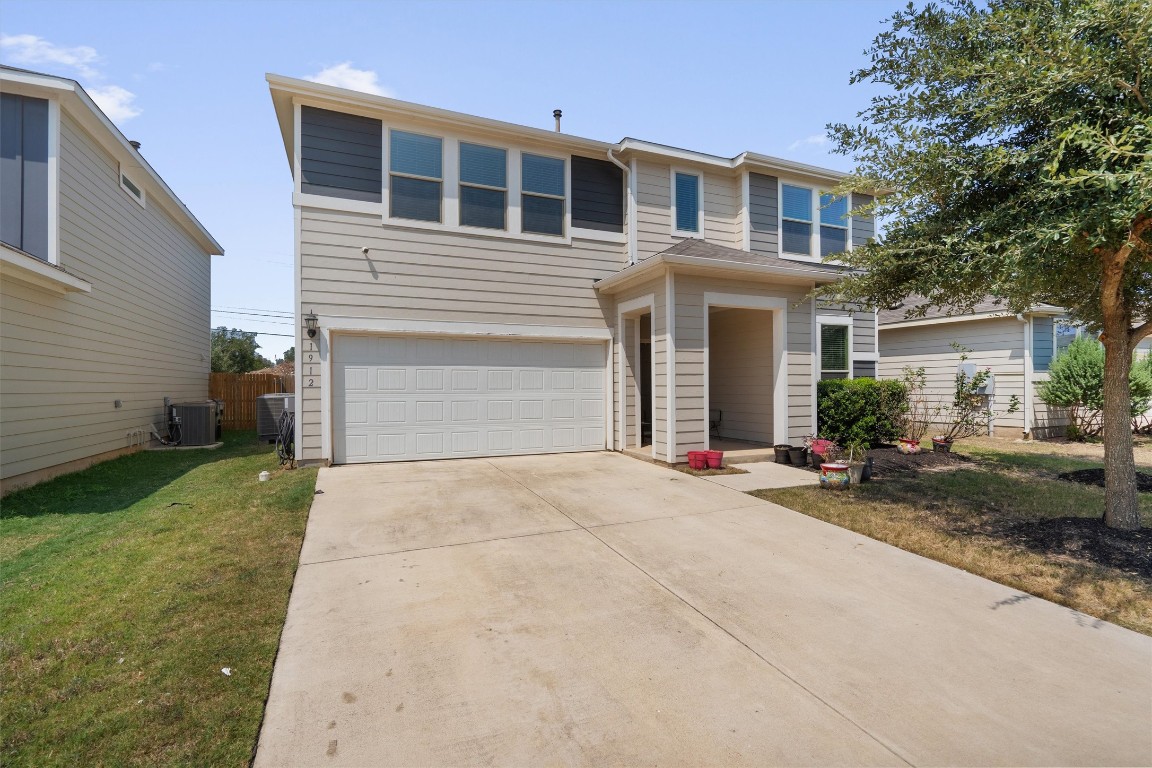 1912 Rinker Ranch Drive Austin, TX 78725 - Photo 1 of 1 a front view of a house with a yard and garage