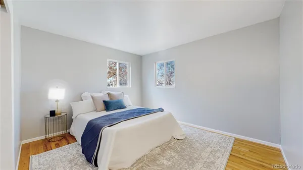 a bedroom with a bed and a painting on the wall
