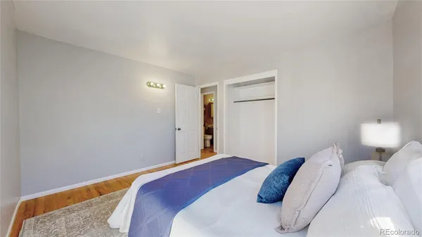 a bedroom with a bed and a lamp