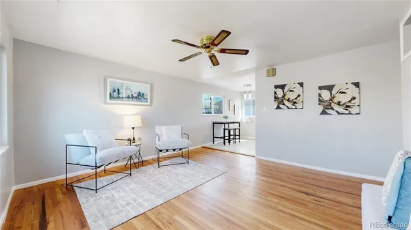 a living room with furniture and wooden floor