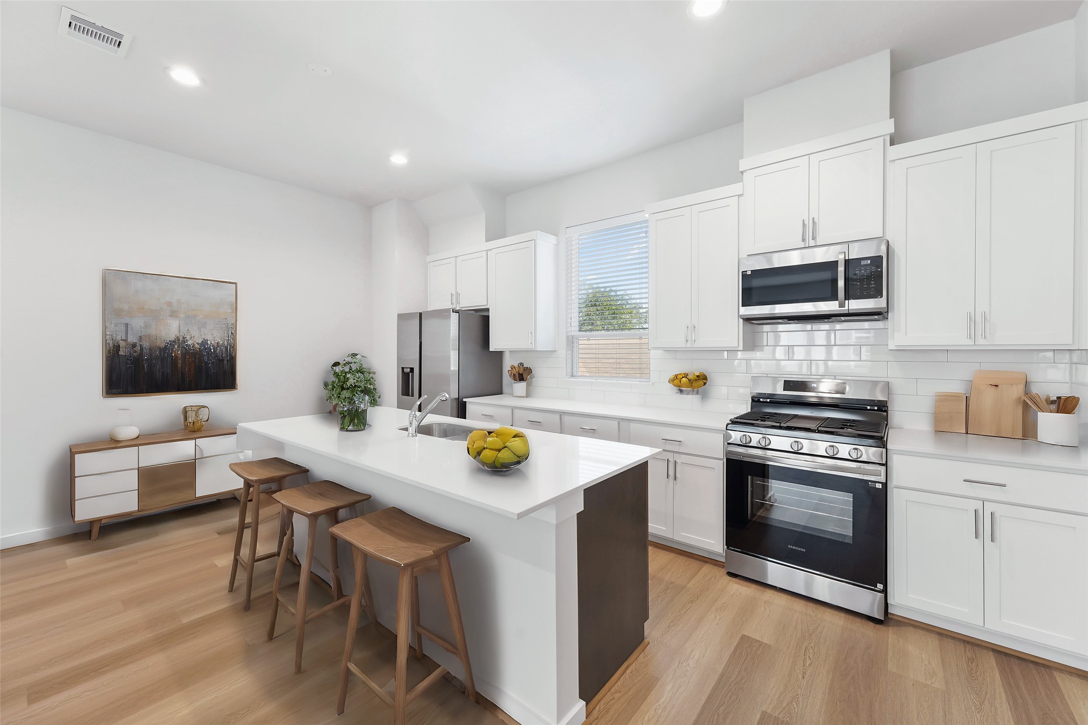 1013 Erin Street, Unit V Houston, TX 77009 - Photo 5 of 25 a kitchen with a sink a stove and chairs