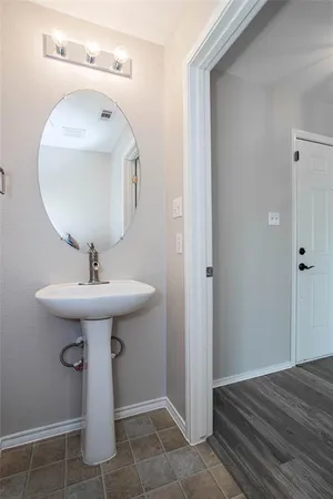 a bathroom with a sink a mirror and toilet