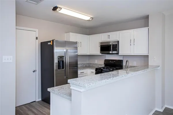 a kitchen with a refrigerator sink and microwave