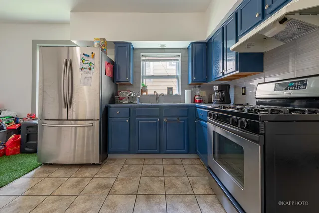 a kitchen with stainless steel appliances granite countertop a refrigerator stove and sink