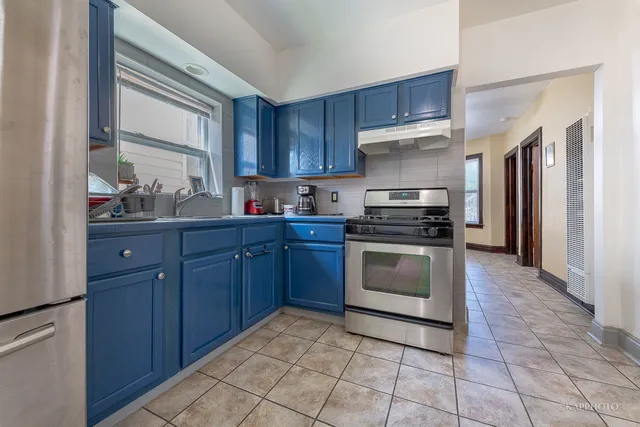 a kitchen with a stove sink and a refrigerator