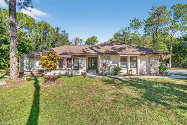 a front view of a house with swimming pool having outdoor seating