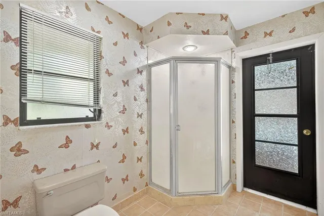 a spacious bathroom with a double vanity sink mirror and shower