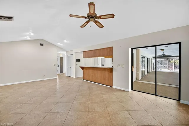 a view of an empty room with a ceiling fan