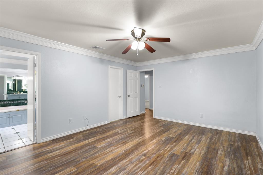 1109 Pine Ridge Drive Azle, TX 76020 - Photo 11 of 24 This room features wood-look flooring, light blue walls, and white crown molding