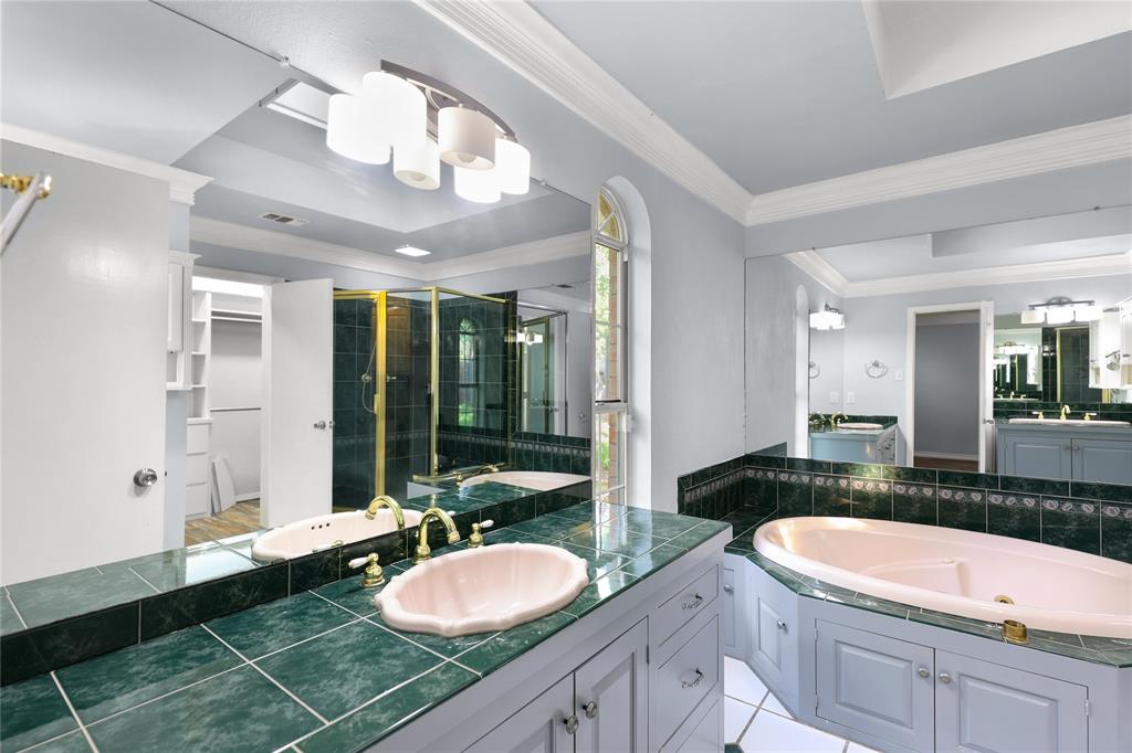 1109 Pine Ridge Drive Azle, TX 76020 - Photo 14 of 24 The bathroom features a spacious vanity with dual sinks and ample countertop space, a built-in bathtub, and a separate shower enclosure