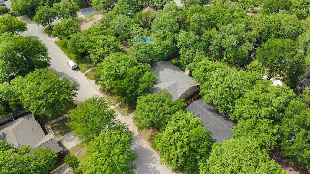 1109 Pine Ridge Drive Azle, TX 76020 - Photo 24 of 24 Aerial view of the property and its surrounding area, showcasing the tree-lined streets and lush green landscaping