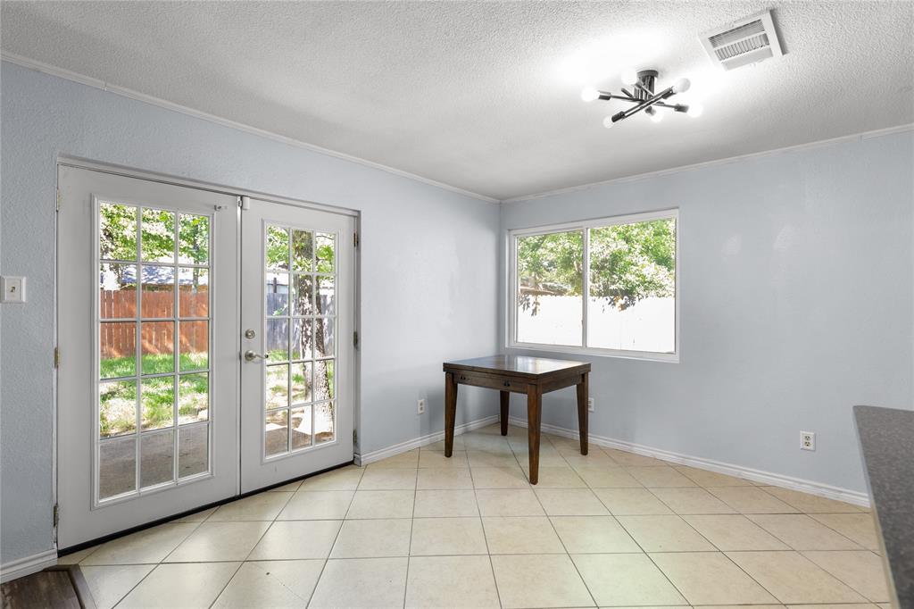 1109 Pine Ridge Drive Azle, TX 76020 - Photo 8 of 24 This room features light-colored walls, tile flooring, and a modern ceiling light fixture