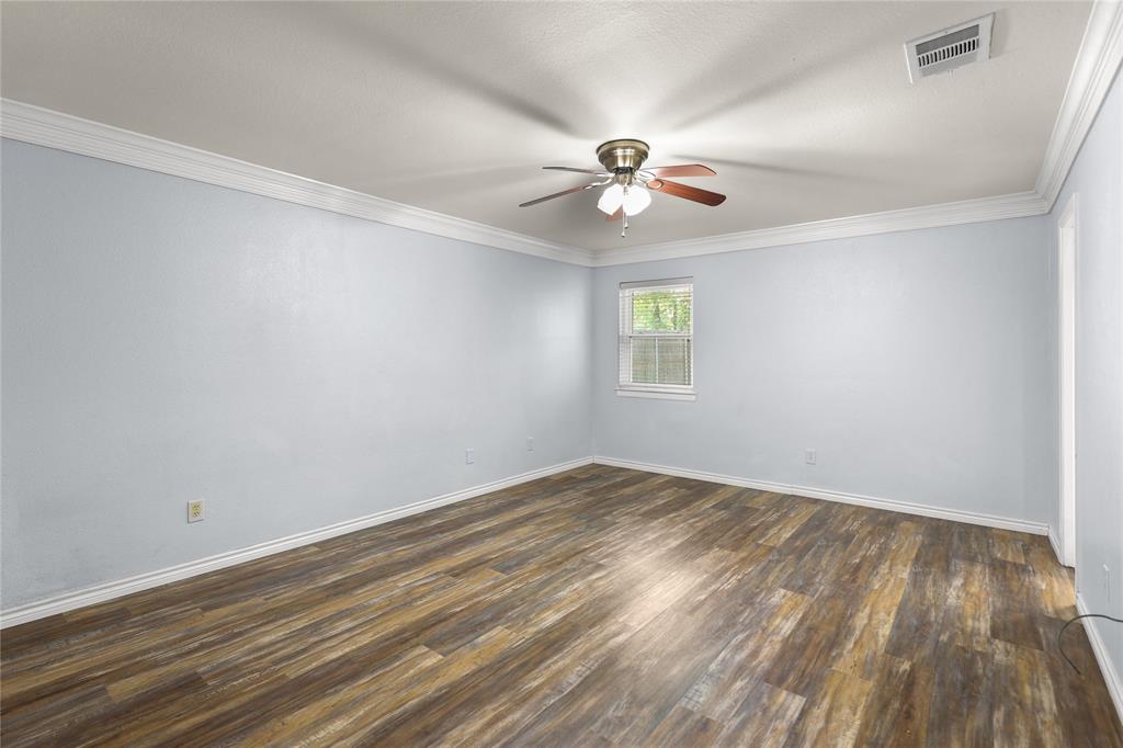 1109 Pine Ridge Drive Azle, TX 76020 - Photo 10 of 24 This room features durable plank flooring, a ceiling fan with light fixture, and a window providing natural illumination