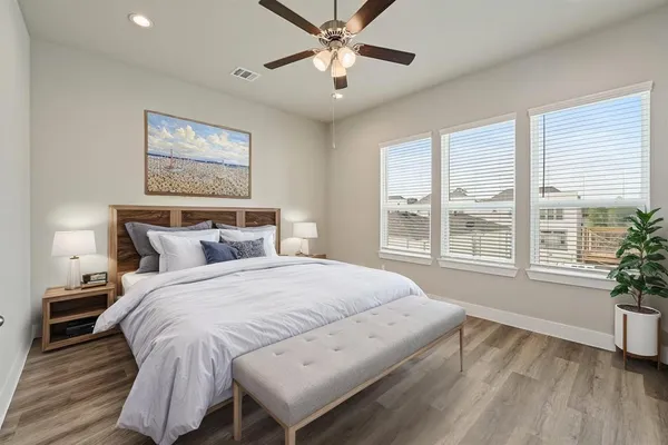 a spacious bedroom with a bed and a large window