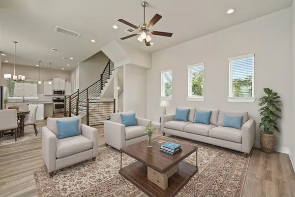 a living room with furniture ceiling fan and a rug