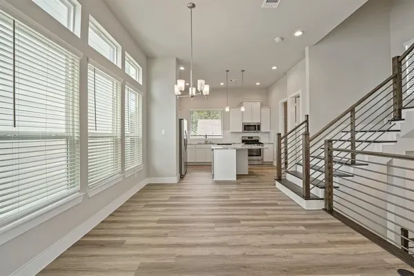 a view of kitchen with sink and refrigerator