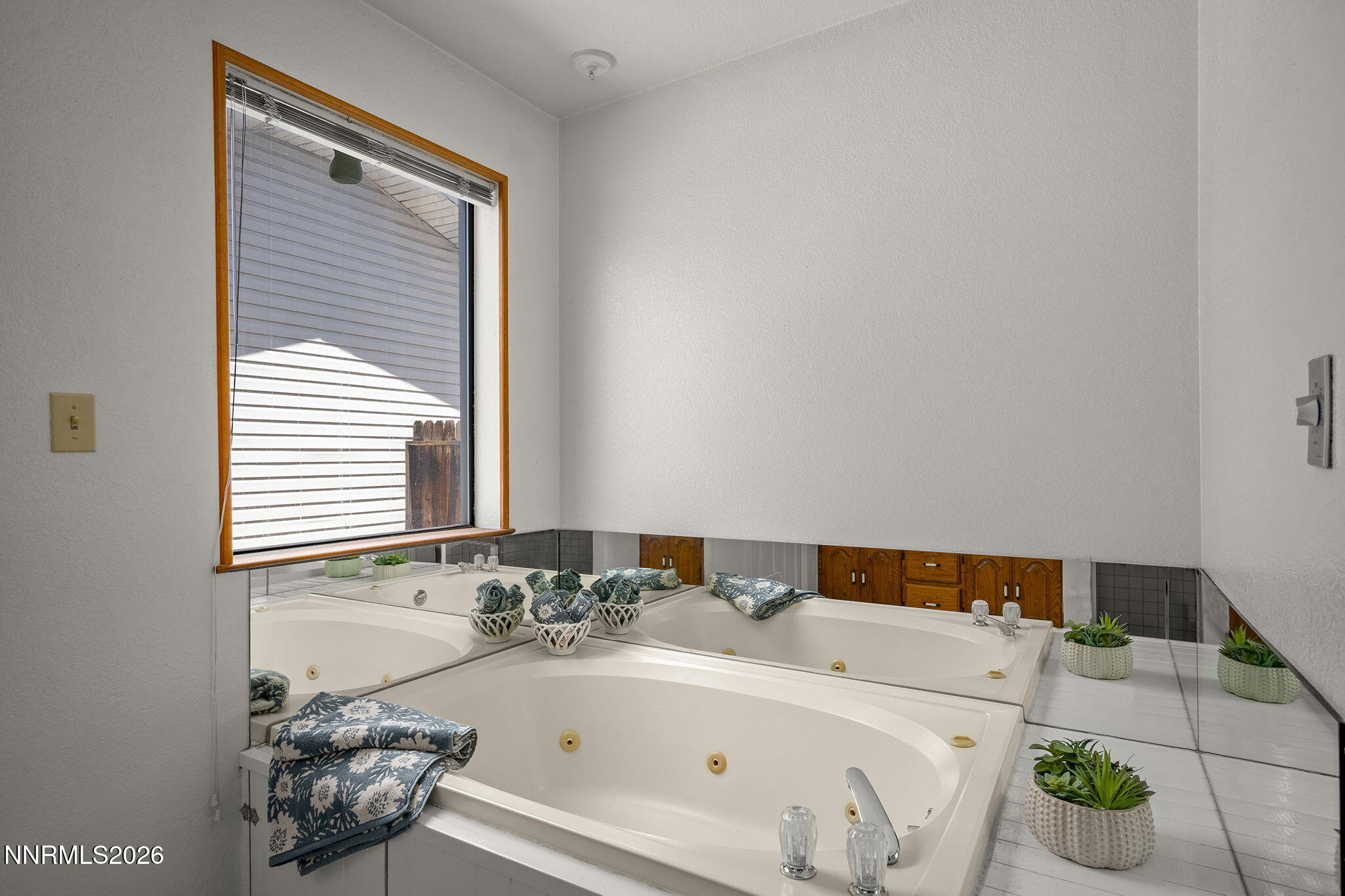 2985 Socrates Drive Reno, NV 89512 - Photo 44 of 52 a bathroom with a bathtub and a window