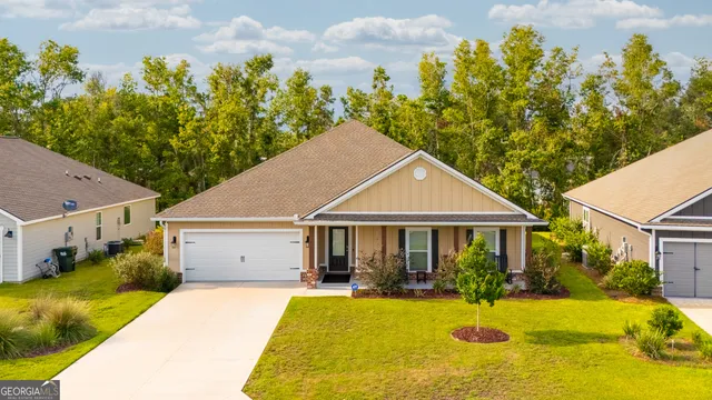 a front view of a house with yard patio and swimming pool