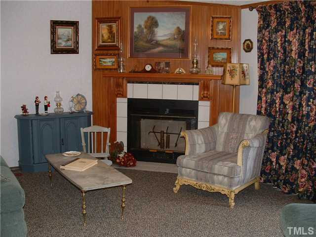 561 George Sherman Road Rougemont, NC 27572 - Photo 7 of 24 Enjoy a good book by the beautiful fireplace. Notice the detail given to the mantel.