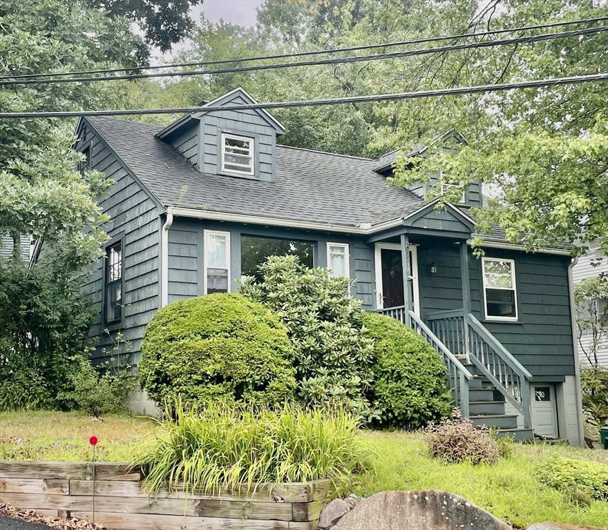 an aerial view of a house with a yard