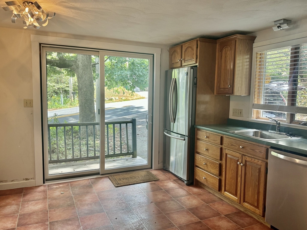 10 Beech Street Billerica, MA 01821 - Photo 4 of 21 a open kitchen with granite countertop a refrigerator and cabinets