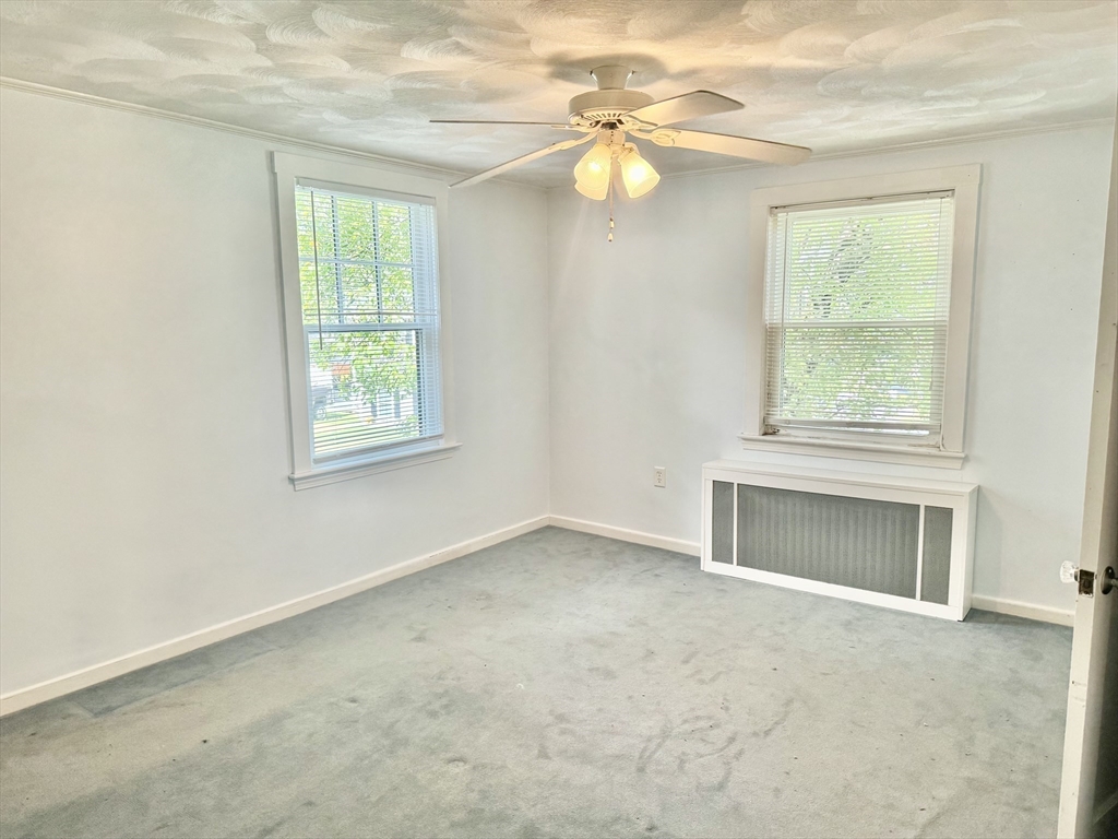 10 Beech Street Billerica, MA 01821 - Photo 7 of 21 an empty room with windows and fireplace