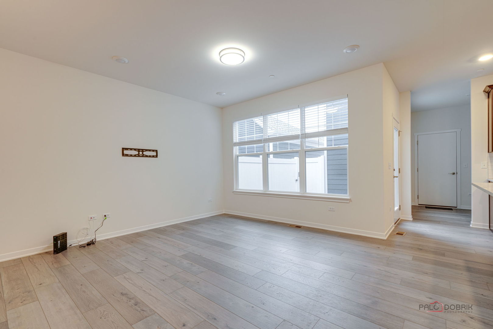 356 Hoffmann Drive Buffalo Grove, IL 60089 - Photo 12 of 35 an empty room with wooden floor and windows