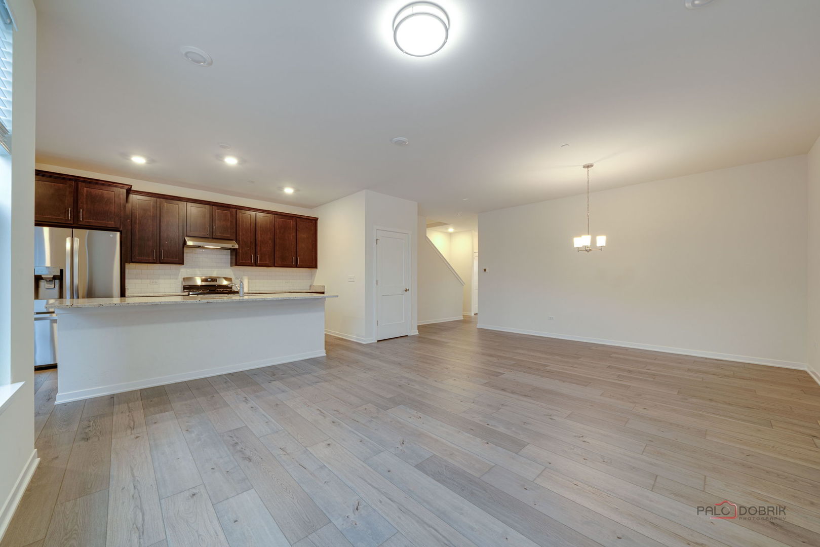 356 Hoffmann Drive Buffalo Grove, IL 60089 - Photo 14 of 35 a view of kitchen with wooden floor and window