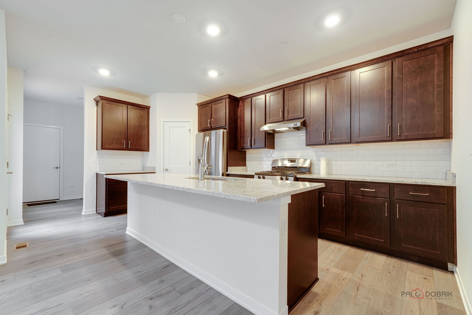356 Hoffmann Drive Buffalo Grove, IL 60089 - Photo 15 of 35 a kitchen with kitchen island granite countertop wooden cabinets a stove a sink and dishwasher