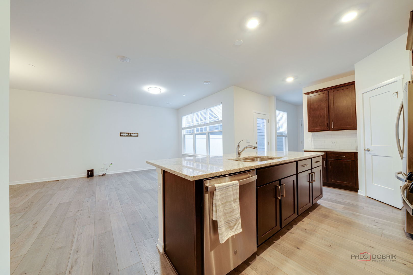 356 Hoffmann Drive Buffalo Grove, IL 60089 - Photo 19 of 35 a kitchen with stainless steel appliances granite countertop a sink and a stove top oven with wooden floor