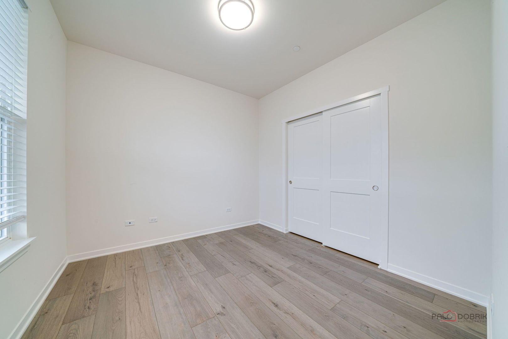 356 Hoffmann Drive Buffalo Grove, IL 60089 - Photo 6 of 35 an empty room with wooden floor and windows