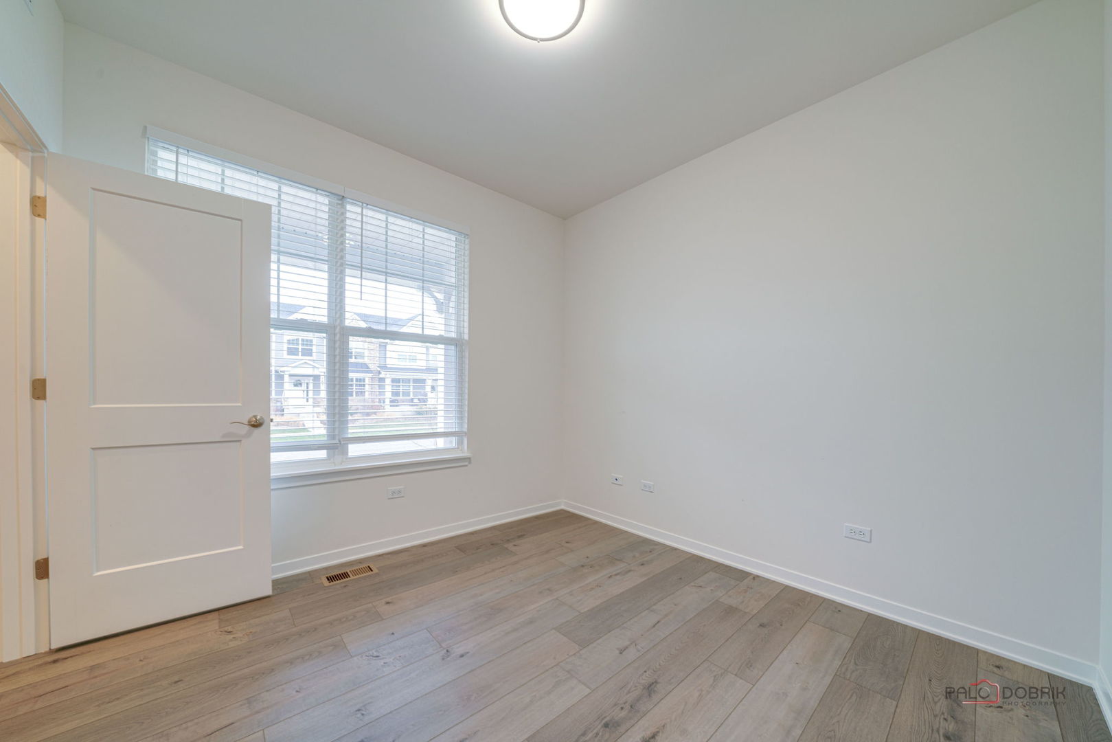 356 Hoffmann Drive Buffalo Grove, IL 60089 - Photo 7 of 35 an empty room with wooden floor and windows